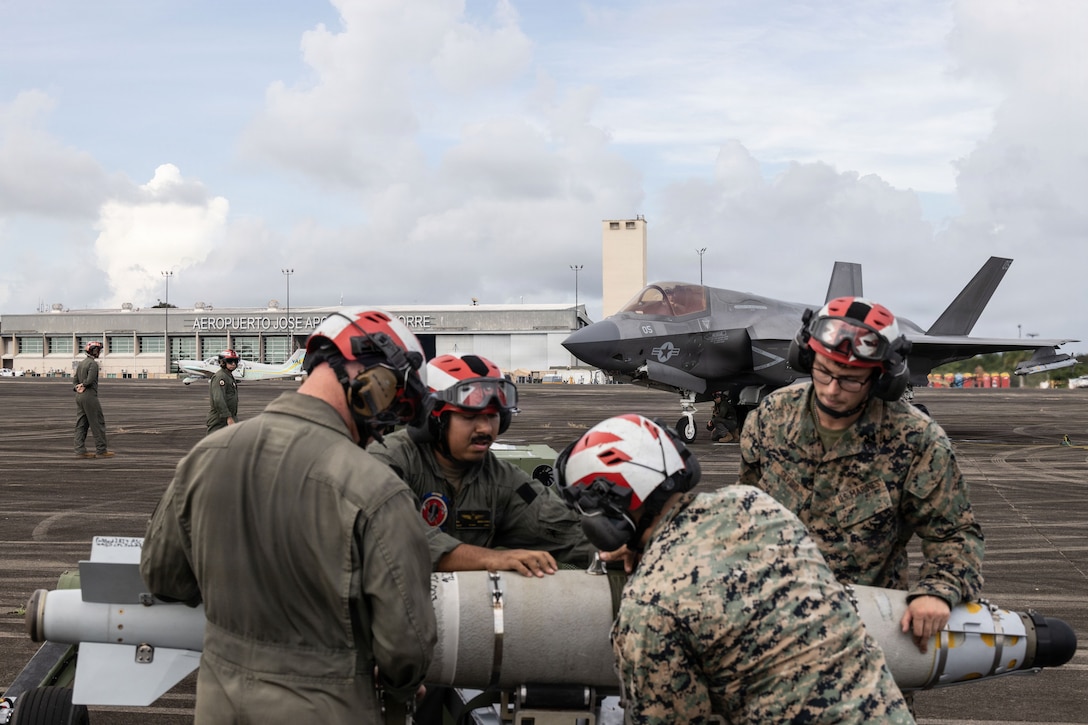 U.S. Marines with Marine Fighter Attack Squadron (VMFA) 225, U.S. Marine Corps Forces, South, secure a GBU-54 Laser Joint Direct Attack Munition onto a Short for Airfield Tactical Support  during a hot load training at Jose Aponte de la Torre Airport in Ceiba, Puerto Rico, Oct. 31, 2025.  U.S. military forces are deployed to the Caribbean in support of the U.S. Southern Command mission, Department of War-directed operations, and the president’s priorities to disrupt illicit drug trafficking and protect the homeland. (U.S. Marine Corps photo)