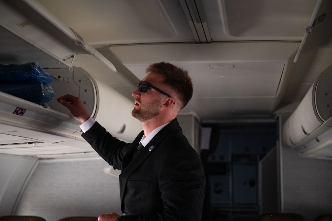 Person checks overhead bin