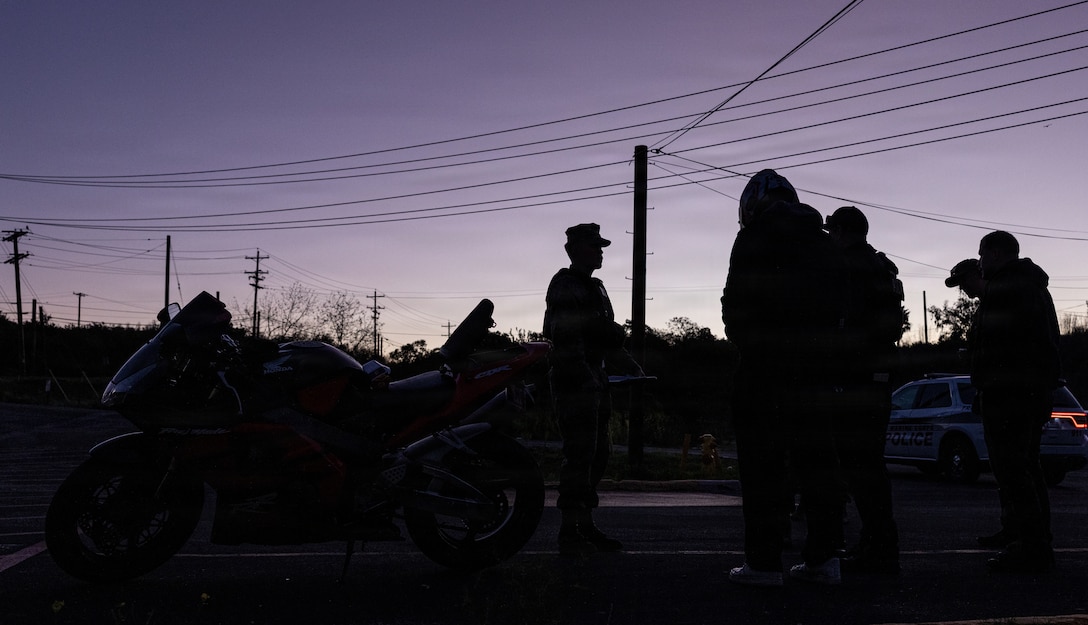 U.S. Marines and civilians with the Provost Marshal's Office with Headquarters and Support Battalion conduct personal protective equipment, registration, and insurance inspections during Operation Full Stop at Marine Corps Base Camp Pendleton, California, Dec. 1, 2025. Operation Full Stop is designed to ensure 100% compliance with motorcycle personal protective equipment and legal regulations. (U.S. Marine Corps photo by Cpl. Jacqueline Akamelu)