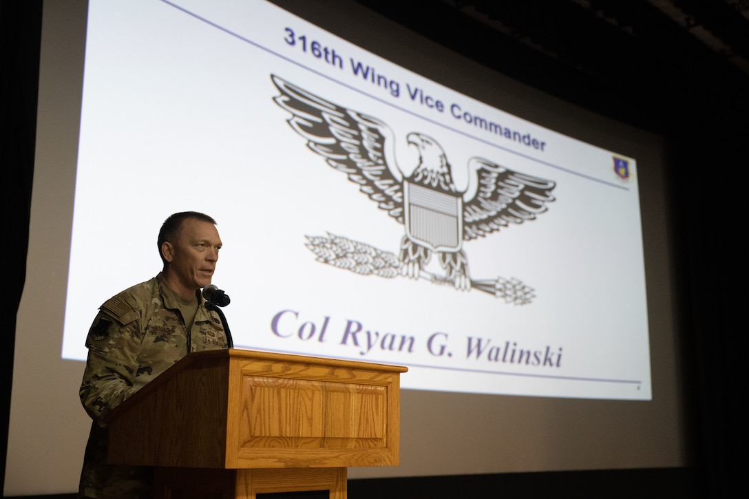 Person stands at podium.