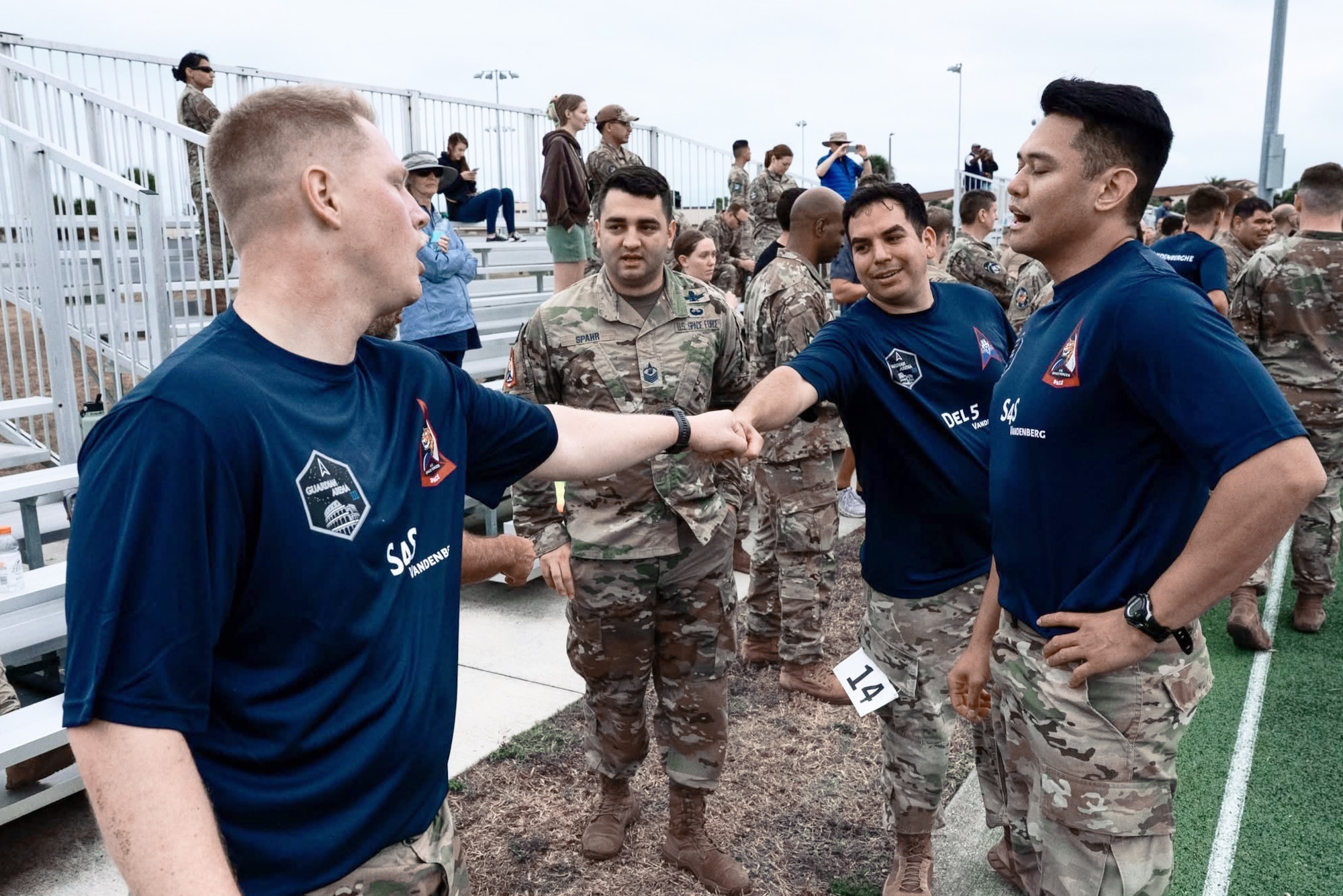 Two men in customized team shirts fist bump