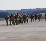 U.S. Army Soldiers with the 170th Military Police Battalion walk from a C-130 on Dobbins Air Reserve Base after returning home from D.C., December 9, 2025. The unit supported the D.C. Safe and Beautiful mission by providing critical assistance to the Metropolitan Police Department and community partners to enhance public safety and quality of life throughout the district.