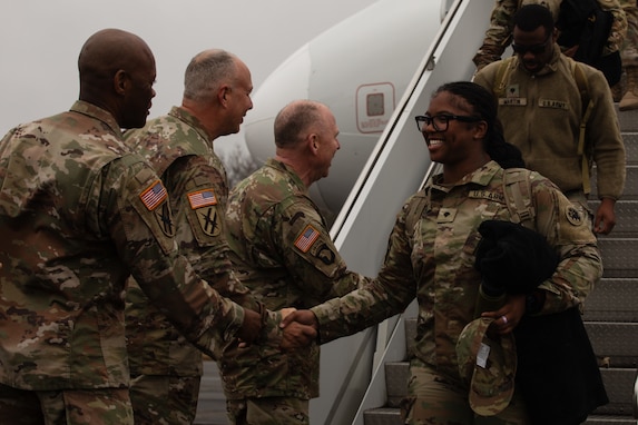 U.S. Army Spc. Xaria Victor, a culinary specialist with the Kennesaw-based 277th Maintenance Company, 110th Combat Sustainment Support Battalion, 78th Troop Command, Georgia Army National Guard, disembarks her return flight before the Welcome Home Ceremony at Hangar Five, Clay National Guard Center, Marietta, Georgia, December 2, 2025. The 277th Maintenance Company has supported numerous emergency response operations and has most recently provided personnel and expertise in support of Joint Task Force-Southern Border (JTF-SB).  (U.S. Army National Guard photo by Staff Sgt. Allison Ahearn)