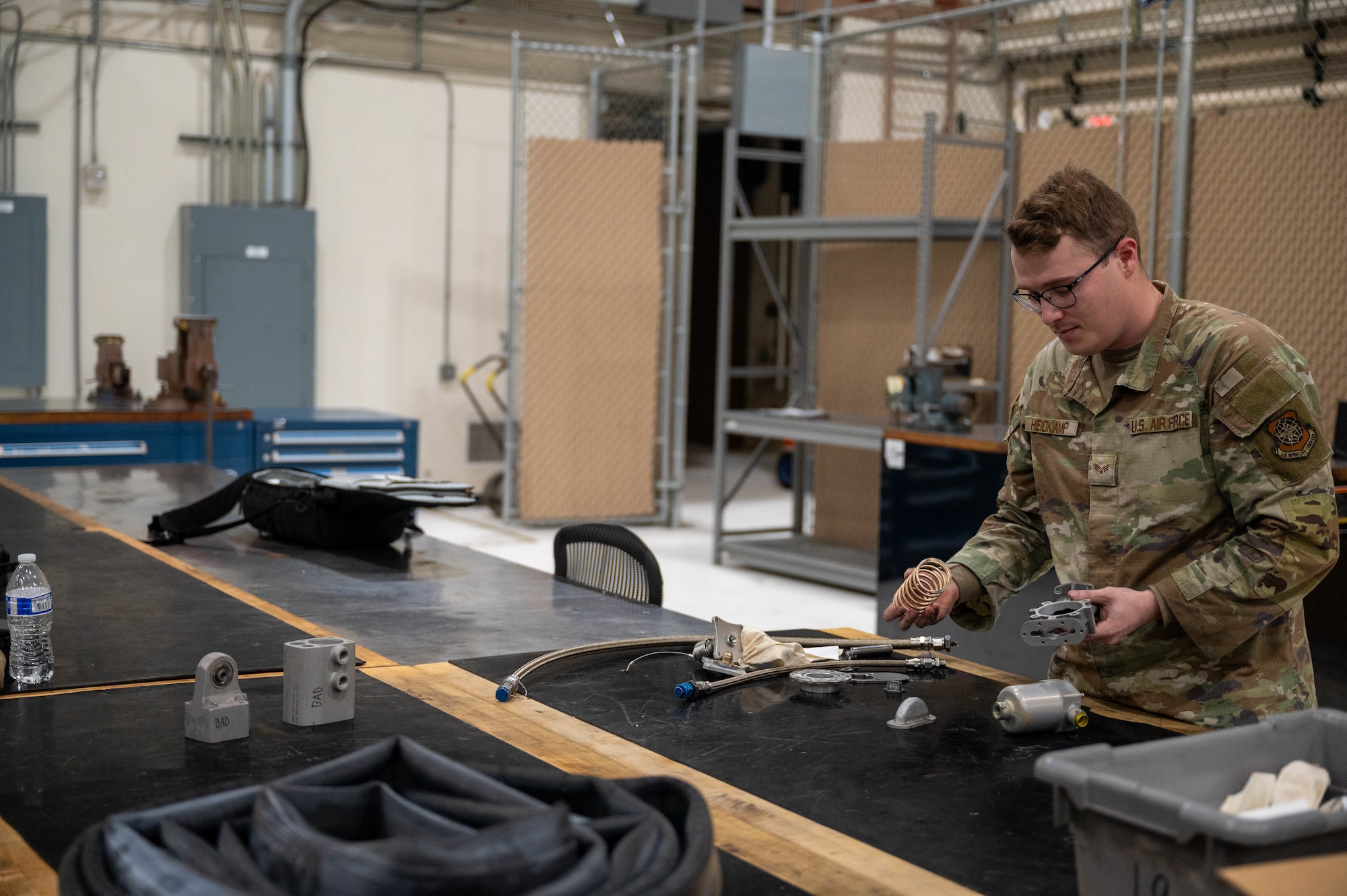 Senior Airman Andrew Heidkamp, 22nd Maintenance Squadron, hydraulics technician, pieces together a KC-46 Fuel valve Dec. 1, 2025, at McConnell Air Force Base, Kansas. This valve ensures the fuel is retracted back into the KC-46 before the boom is stowed during flight. (U.S. Air Force photo by Senior Airman William Lunn)