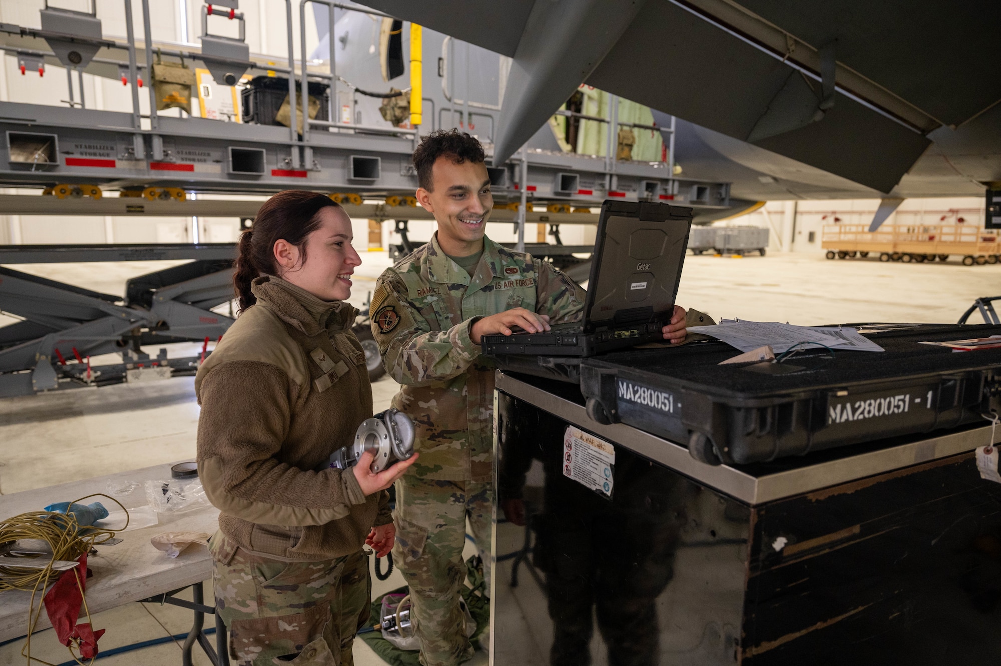 Airman 1st Class Katelyn Dimian and Senior Airman Junior Ramirez, 22nd Maintenance Squadron aircraft fuel systems specialists, work to install a KC-46 fuel valve Dec. 1, 2025, at McConnell Air Force Base, Kansas. This valve ensures the fuel is retracted back into the KC-46 before the boom is stowed during flight. (U.S. Air Force photo by Senior Airman William Lunn)