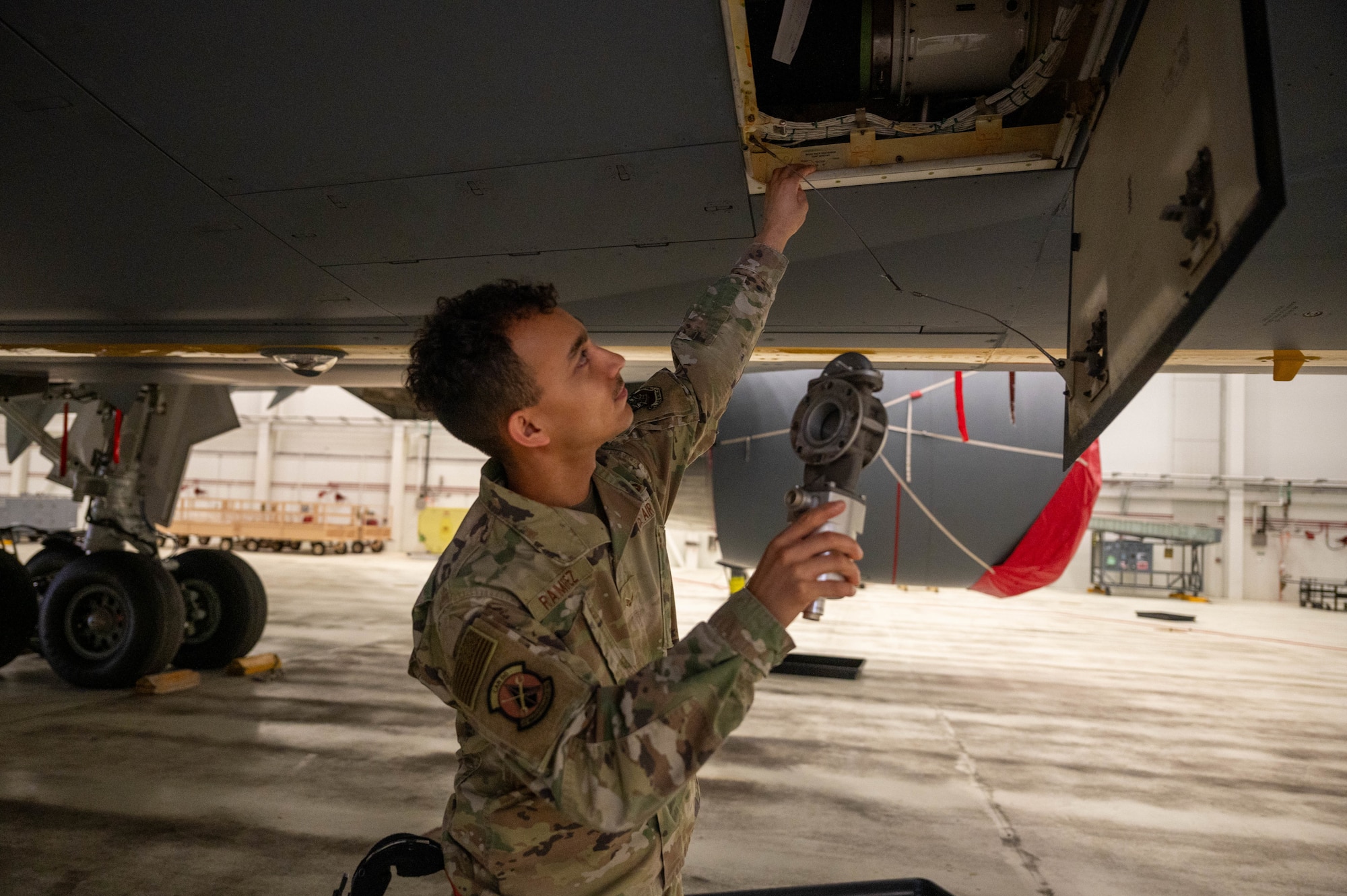 Senior Airman Junior Ramirez, 22nd Maintenance Squadron, aircraft fuel systems specialist, prepares to replace a KC-46 fuel valve Dec. 1, 2025, at McConnell Air Force Base, Kansas. This valve ensures the fuel is retracted back into the KC-46 before the boom is stowed during flight. (U.S. Air Force photo by Senior Airman William Lunn)