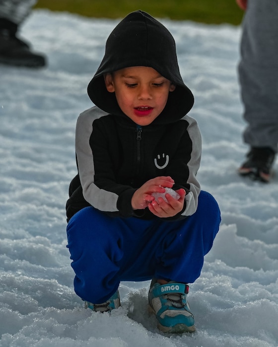 A military child plays with snow, Dec. 5, 2025, at Luke Air Force Base, Arizona.