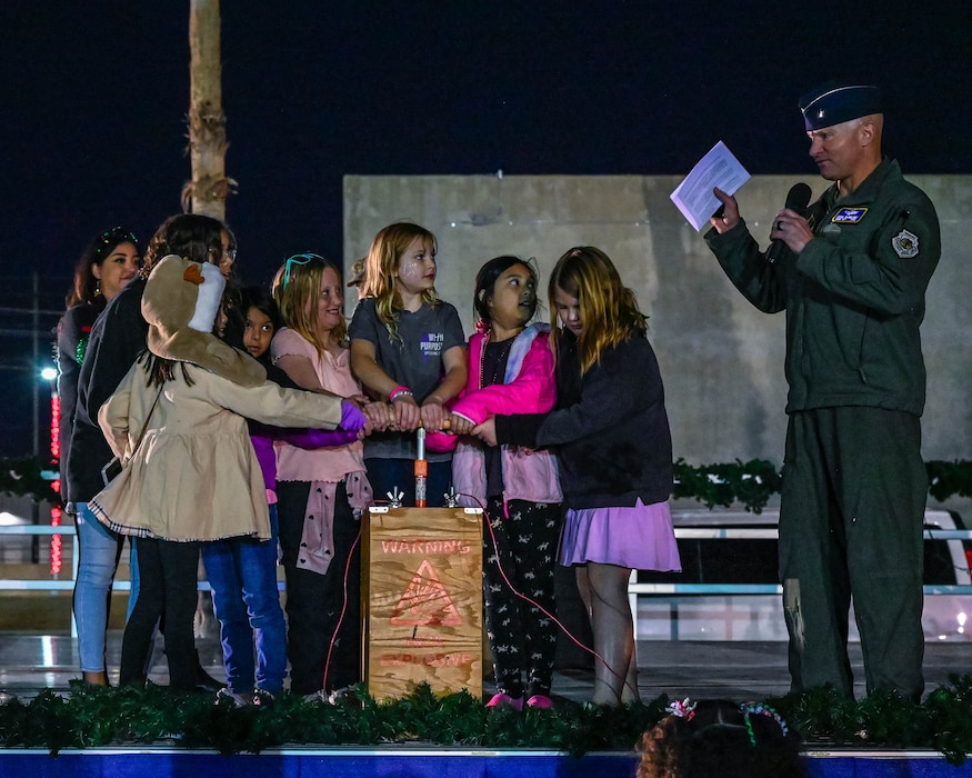 Military children prepare to light up a Christmas tree with Brig. Gen. David Berkland, 56th Fighter Wing commander, Dec. 5, 2025, at Luke Air Force Base, Arizona.