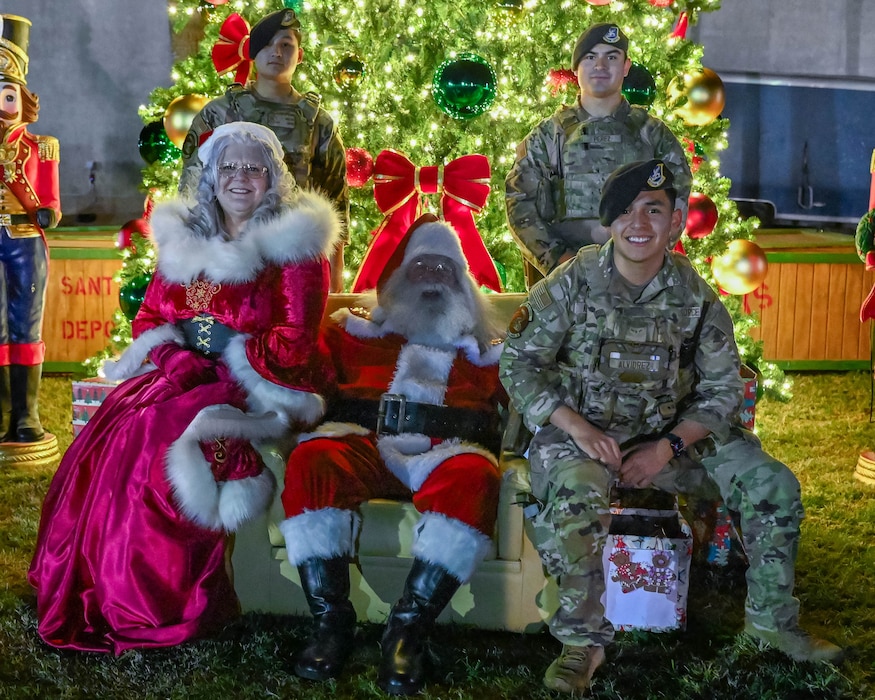 Santa Claus and Mrs. Claus pose for a photo, with the 56th Fighter Wing defenders, Dec. 5, 2025, at Luke Air Force Base, Arizona.