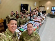 A photo of base leadership posing for a photo with the volunteer team.