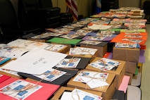 A photo of boxes of cookies labeled by the squadrons receiving them.
