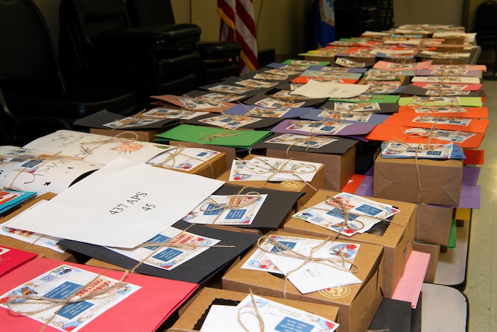 A photo of boxes of cookies labeled by the squadrons receiving them.