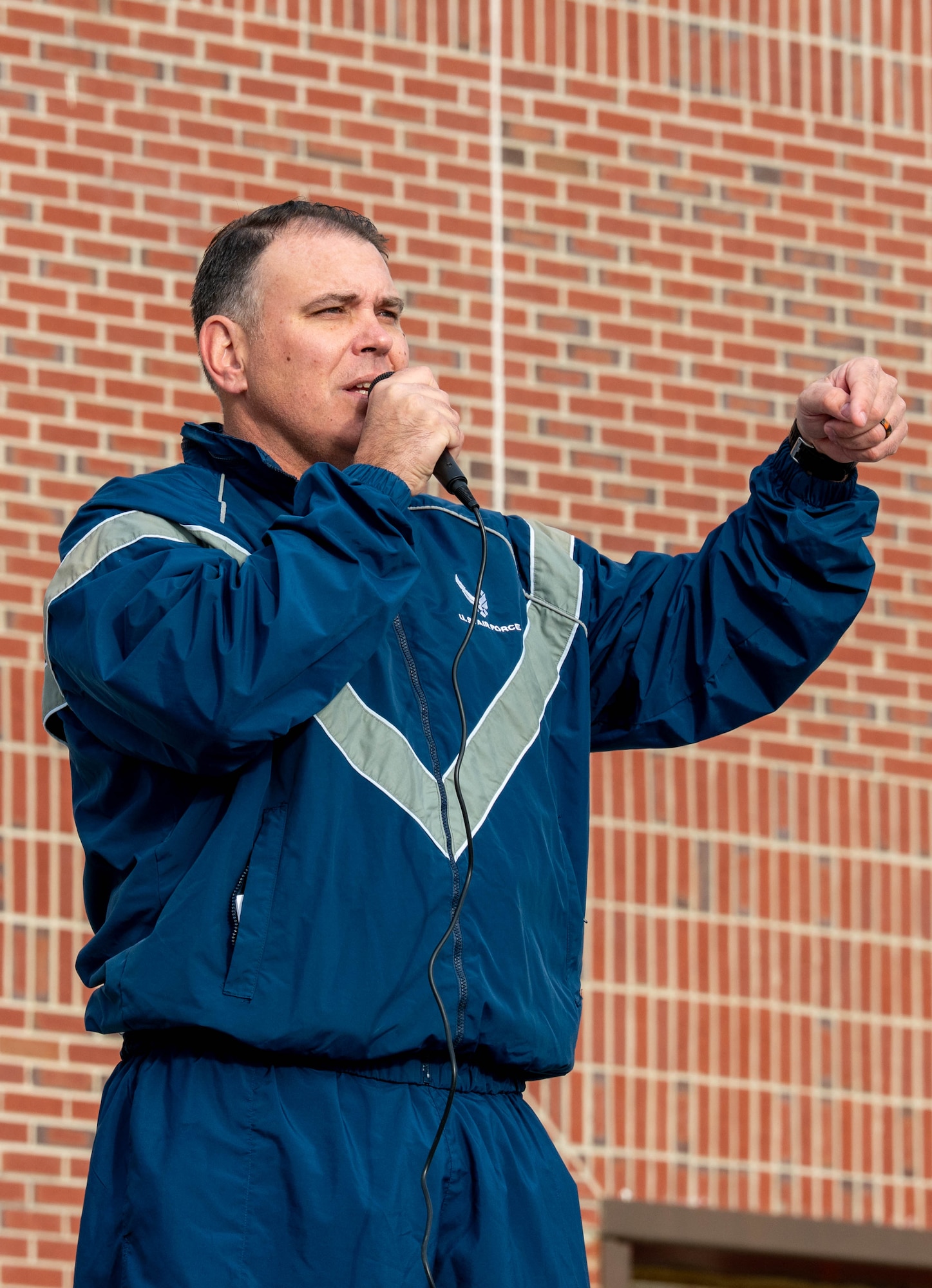 A photo of a man speaking to a crowd.