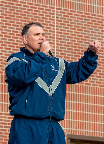 A photo of a man speaking to a crowd.