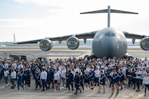 A photo of several people beginning to run.