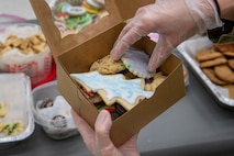 A photo of an Airman packaging cookies.