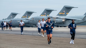 A photo of several people running.