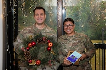 A photo of a First Sergeant and an Airman smiling.