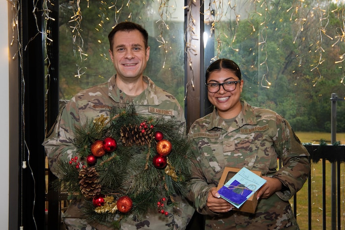 A photo of a First Sergeant and an Airman smiling.