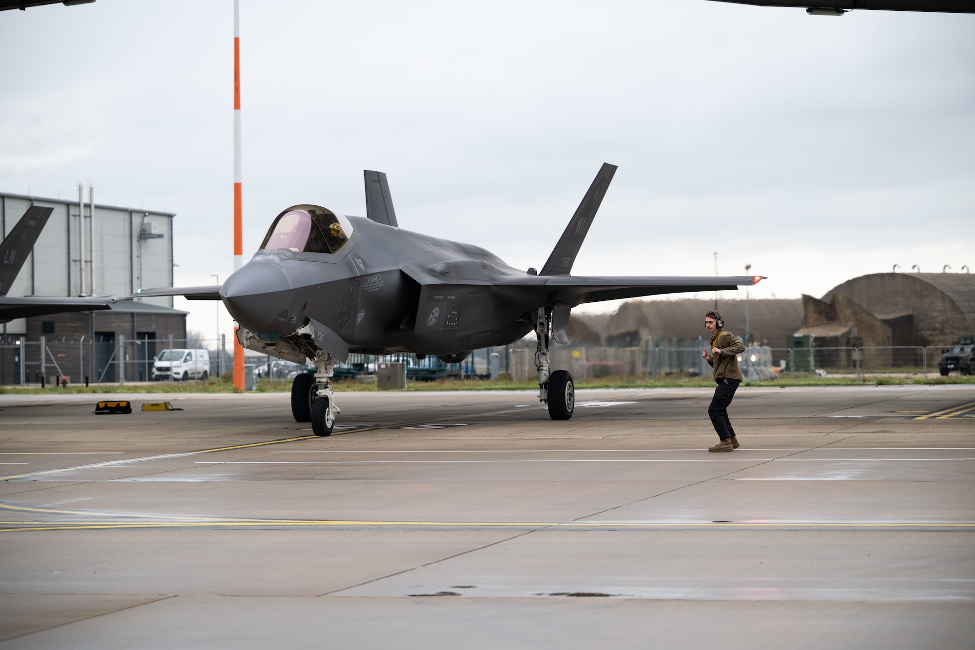 U.S. Air Force Senior Airman Jayden Archuleta, 493rd Fighter Generation Squadron crew chief, monitors the flight preparations for a F-35 Lightning II aircraft before a training mission over the Baltic states from RAF Lakenheath