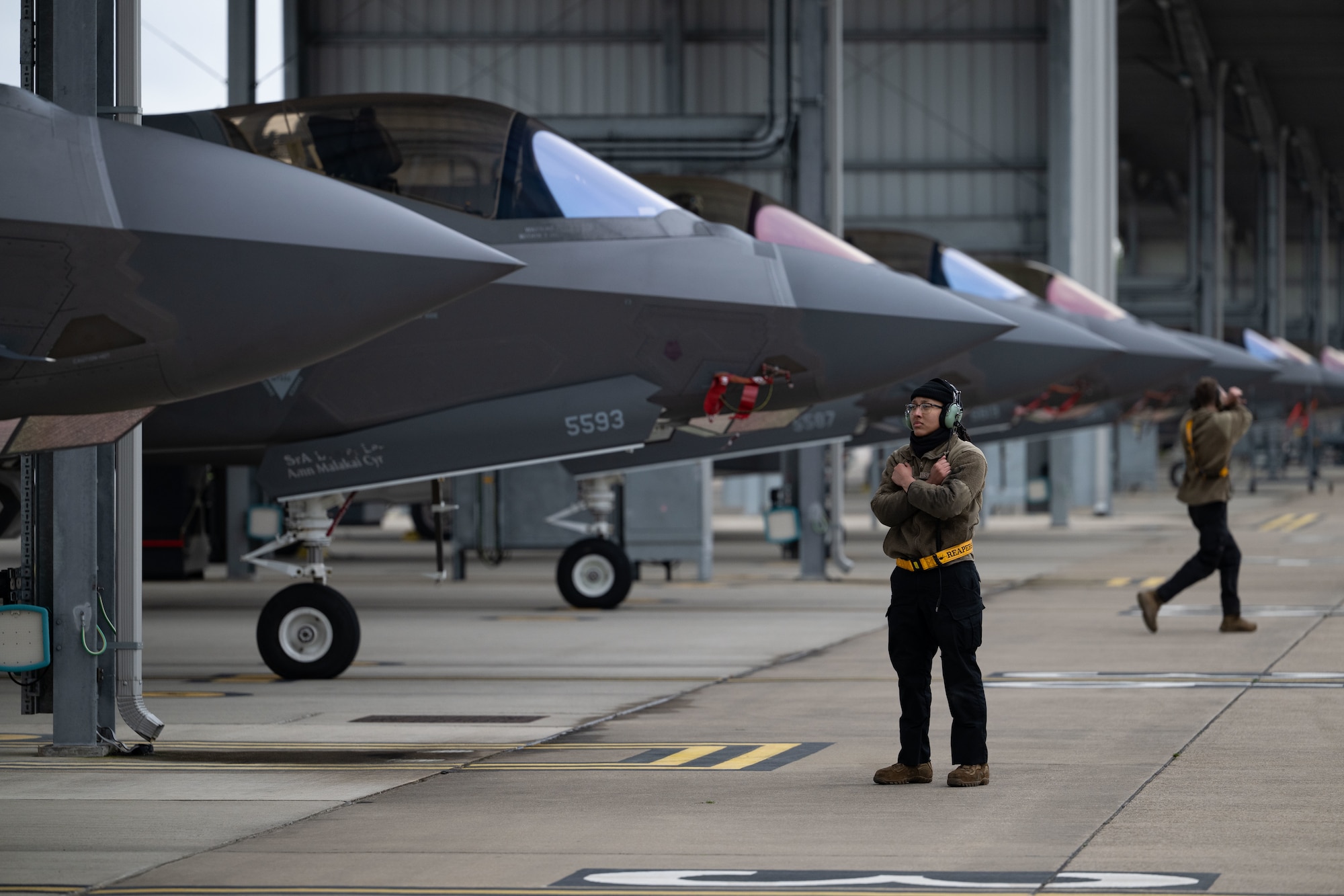 U.S. Air Force Airman 1st Class Angelina Alvarez, 493rd Fighter Generation Squadron crew chief, prepares to marshal a F-35 Lightning II at RAF Lakenheath before a training mission across the Baltic states