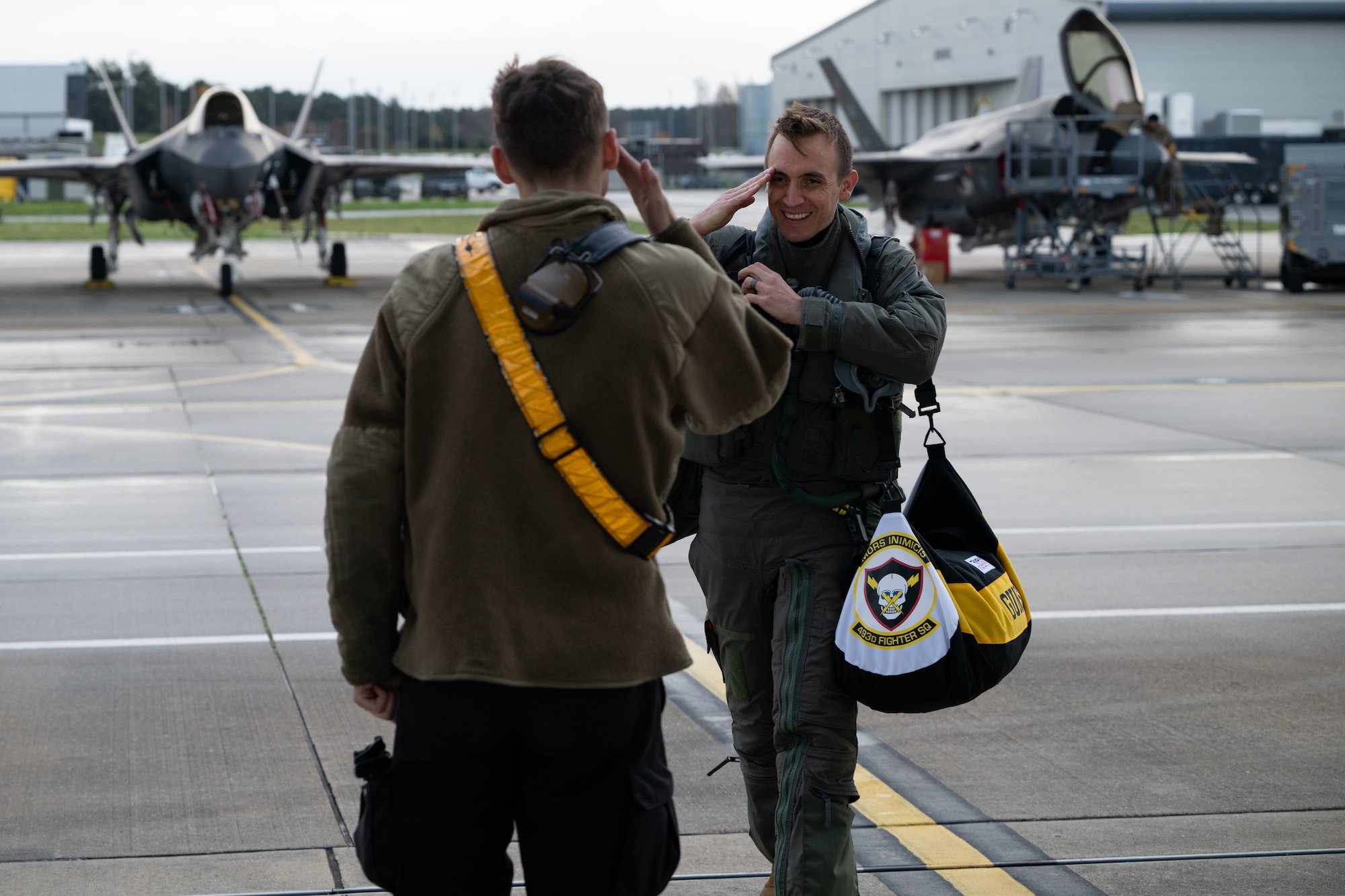 U.S. Air Force Maj. Jordan Rozsa, 493rd Fighter Squadron pilot, greets Senior Airman Jaylen Archuleta, 493rd Fighter Generation Squadron crew chief, before a training mission across the Baltic states from RAF Lakenheath