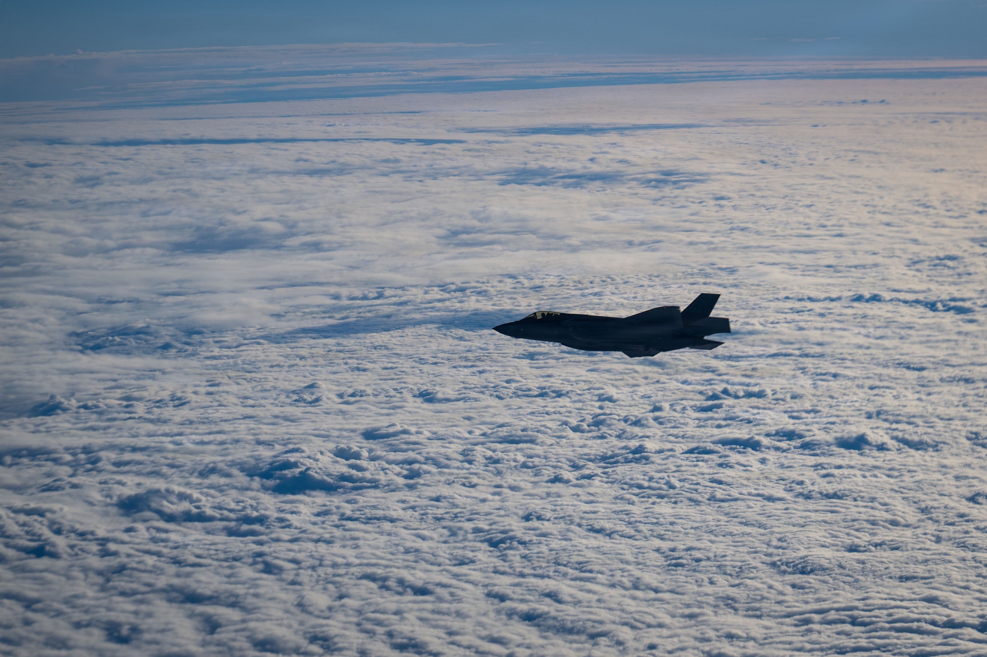 A U.S. Air Force 48th Fighter Wing F-35 Lightning II flies beside a 100th Air Refueling Wing KC-135 Stratotanker, over the Baltic Sea