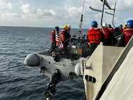Independence-variant littoral combat ship USS Cincinnati (LCS 20) conducts small boat operations and a personnel transfer with Royal Malaysian Navy Lekiu-class guided-missile frigate KD Lekiu (FFG 30) during the sea phase of Cooperation Afloat Readiness and Training (CARAT) Malaysia 2025 in the Strait of Malacca, Dec. 8, 2025.