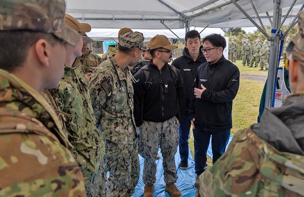 JOGASHIMA PARK, Japan (Nov. 9, 2025) — Doctors Takehiro Mochizuki and Sho Nonoyama, both Japanese Fellows assigned to U.S. Naval Hospital Yokosuka, introduce themselves to their team prior to the start of Big Rescue Kanagawa 2025. The annual exercise is one of Kanagawa Prefecture’s largest disaster-response drills, involving U.S. Naval Hospital Yokosuka, Red Cross Yokosuka and Branch Health Clinic Atsugi personnel working alongside U.S. and Japanese agencies. (U.S. Navy photo by Daniel Taylor/USNMRTC Public Affairs)