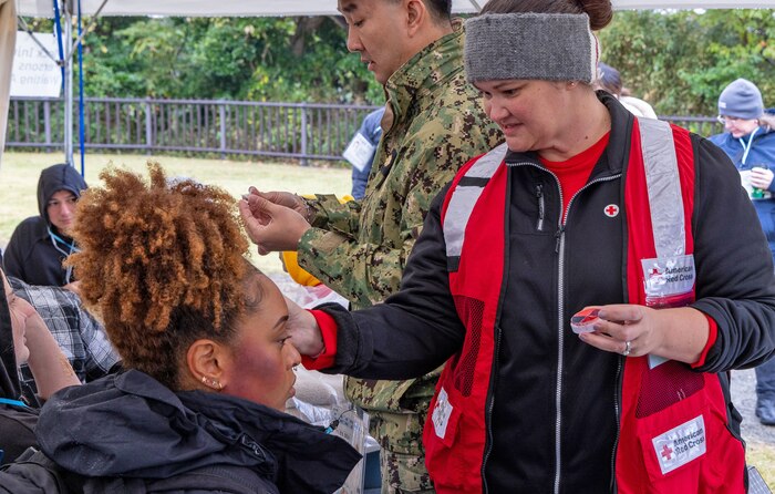 JOGASHIMA PARK, Japan (Nov. 9, 2025) — A volunteer with American Red Cross Yokosuka applies moulage to a simulated casualty during Big Rescue Kanagawa 2025. The annual exercise is one of Kanagawa Prefecture’s largest disaster-response drills, involving U.S. Naval Hospital Yokosuka, Red Cross Yokosuka and Branch Health Clinic Atsugi personnel working alongside U.S. and Japanese agencies. (U.S. Navy photo by Daniel Taylor/USNMRTC Public Affairs)