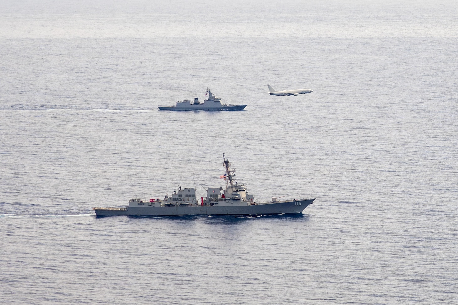 U.S. Navy P-8A Poseidon, assigned to Patrol Squadron (VP) 45, executes a low-altitude flyover as U.S. Navy Arleigh Burke-class guided-missile destroyer USS Rafael Peralta (DDG 115) steams in formation with Philippine Navy Jose Rizal-class frigate BRP Jose Rizal (FF 150) in the South China Sea, Dec. 10.