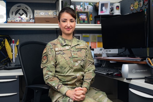 An Airman seated at a work desk.
