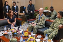 U.S. Navy Capt. Matt Cox, deputy commodore, Destroyer Squadron (DESRON) 7, speaks with U.S. Consul for Sumatra, Lisa Podolny, during the Association of Southeast Asian Nations (ASEAN)-U.S. Maritime Exercise (AUMX) 2025, in Batam, Indonesia, Dec. 10, 2025.