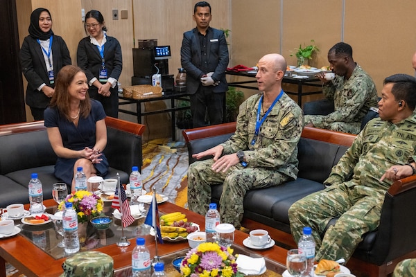U.S. Navy Capt. Matt Cox, deputy commodore, Destroyer Squadron (DESRON) 7, speaks with U.S. Consul for Sumatra, Lisa Podolny, during the Association of Southeast Asian Nations (ASEAN)-U.S. Maritime Exercise (AUMX) 2025, in Batam, Indonesia, Dec. 10, 2025.