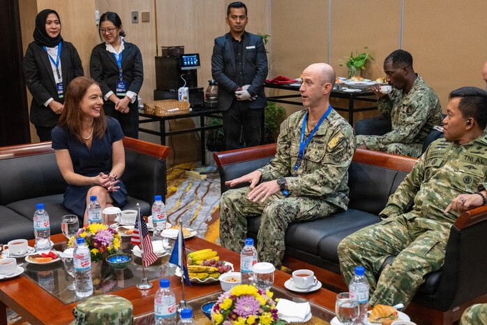 U.S. Navy Capt. Matt Cox, deputy commodore, Destroyer Squadron (DESRON) 7, speaks with U.S. Consul for Sumatra, Lisa Podolny, during the Association of Southeast Asian Nations (ASEAN)-U.S. Maritime Exercise (AUMX) 2025, in Batam, Indonesia, Dec. 10, 2025.
