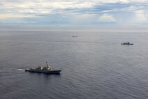 U.S. Navy P-8A Poseidon, assigned to Patrol Squadron (VP) 45, executes a low-altitude flyover as U.S. Navy Arleigh Burke-class guided-missile destroyer USS Rafael Peralta (DDG 115) steams in formation with Philippine Navy Jose Rizal-class frigate BRP Jose Rizal (FF 150) in the South China Sea, Dec. 10.