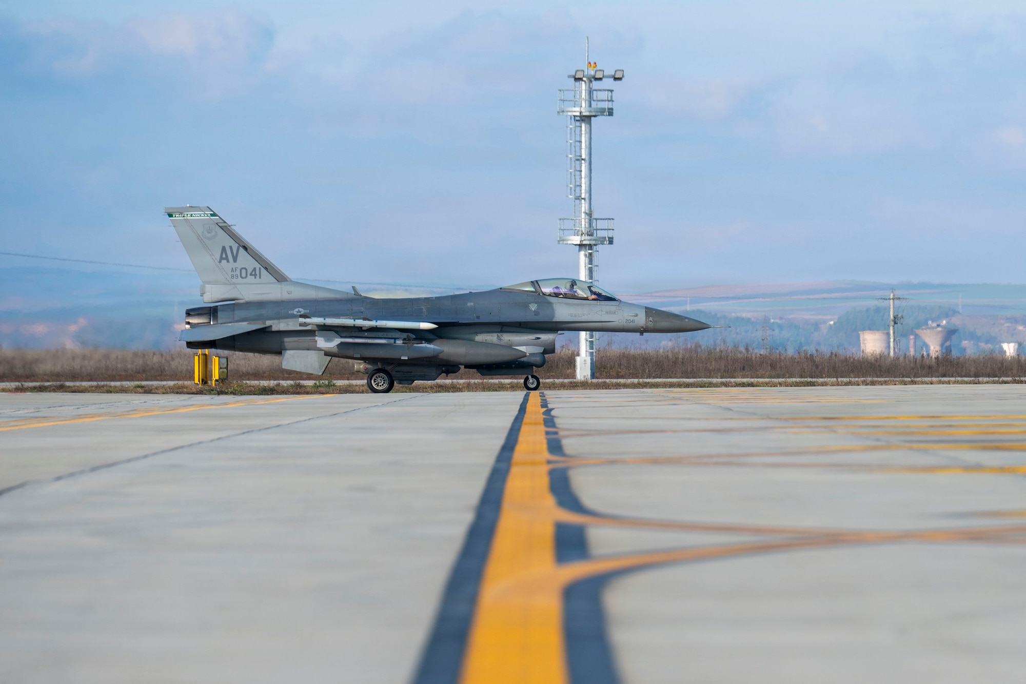 A U.S. Air Force F-16 Fighting Falcon from the 555th Fighter Generation Squadron at Aviano Air Base, Italy, taxis down the runway during routine Agile Combat Employment operations at Campia Turzii, Romania