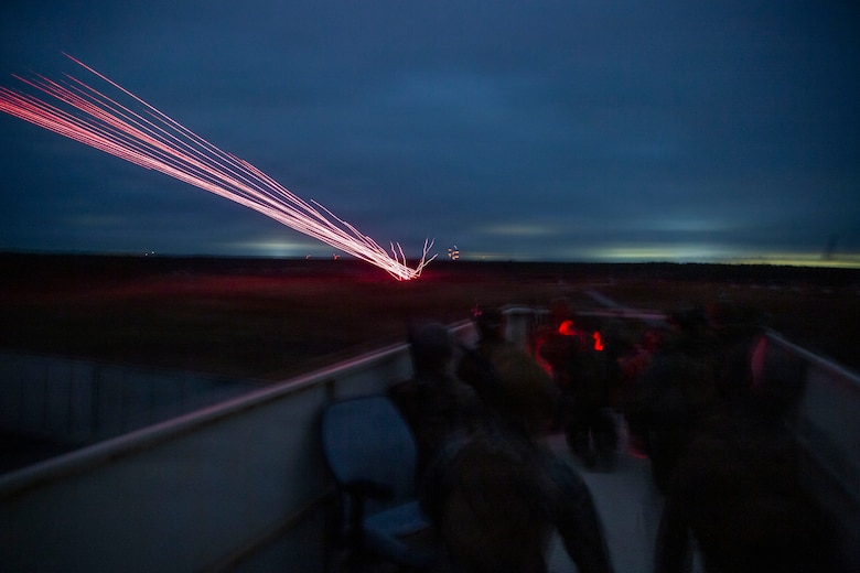 U.S. Marines with 3rd Naval Gunfire Liaison Company, Force Headquarters Group, Marine Forces Reserve, watch incoming close air support hit its target during a tactical air-control party (TACP) exercise at Rattlesnake Range, Hattiesburg, Mississippi, Dec. 2, 2025. TACP exercises prepare prospective joint terminal attack controllers and joint fires observers for formal schools. (U.S. Marine Corps photo by Lance Cpl. Payton Goodrich)
