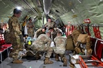 A group of 59th Medical Wing Airmen place a simulated patient and secure their liter onto a KC-135 Stratotanker, Joint Base San Antonio-Kelly Field Annex, Texas, June 18, 2024. A collaboration between the 59th MDW, the 54th Air Refueling Squadron, Critical Care Air Transport Team Pilot Unit, Aeromedical Evacuation National Guard Bureau, and the air evacuation crew from the 137th Special Operations Wing provided an opportunity to conduct joint service training during a CCATT exercise. (U.S. Air Force photo by Senior Airman Melody Bordeaux)