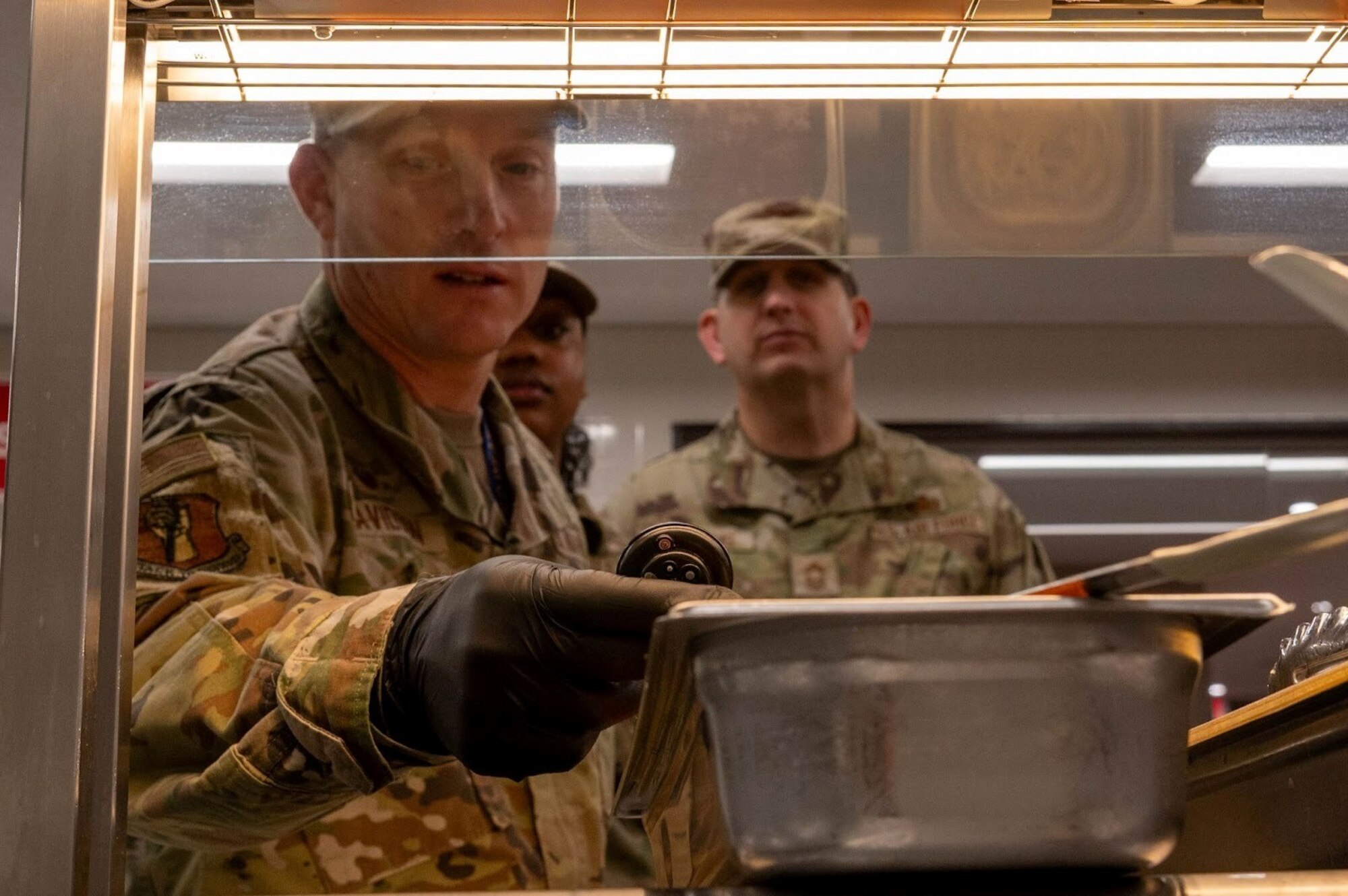 U.S. Air Force Col. Paul Davidson, 35th Fighter Wing (FW) commander, checks the temperature of sauce at Misawa Air Base, Japan, Dec. 8, 2025. Teamwork helps provide the steady food support that fuels the 35th FW’s around-the-clock operations. (U.S. Air Force photo by Airman 1st Class Jessel Fabara)