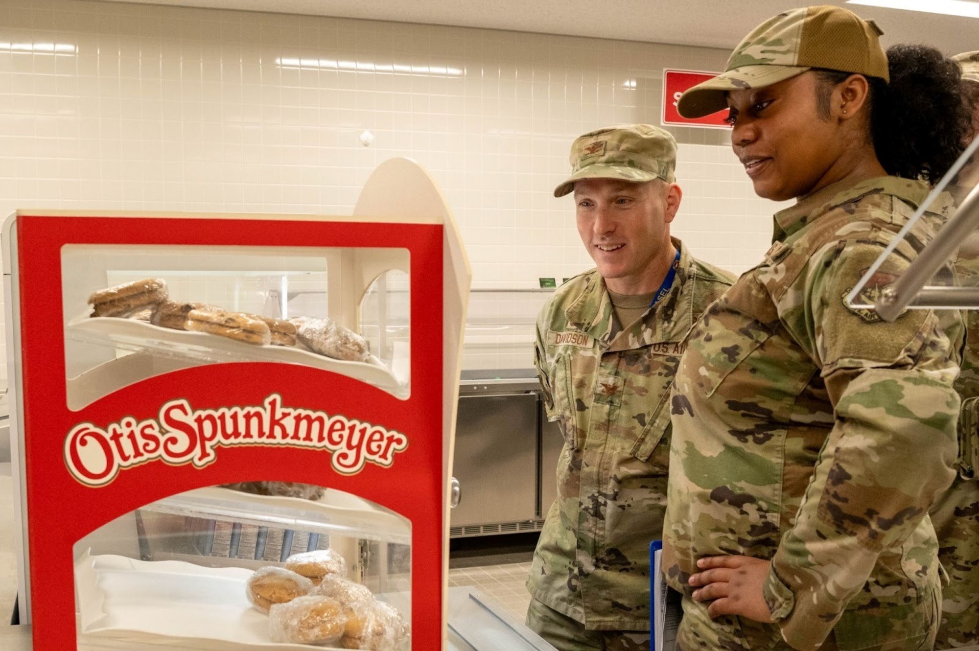 U.S. Air Force Airman 1st Class Tykira Rancifer, 35th Operational Medical Readiness Squadron public health technician, and Col. Paul Davidson, 35th Fighter Wing (FW) commander, inspect a cookie station at Misawa Air Base, Japan, Dec. 8, 2025. As this week’s Wild Weasel of the Week, Rancifer helped ensure base dining operations continue to keep the 35th FW mission-ready. (U.S. Air Force photo by Airman 1st Class Jessel Fabara)
