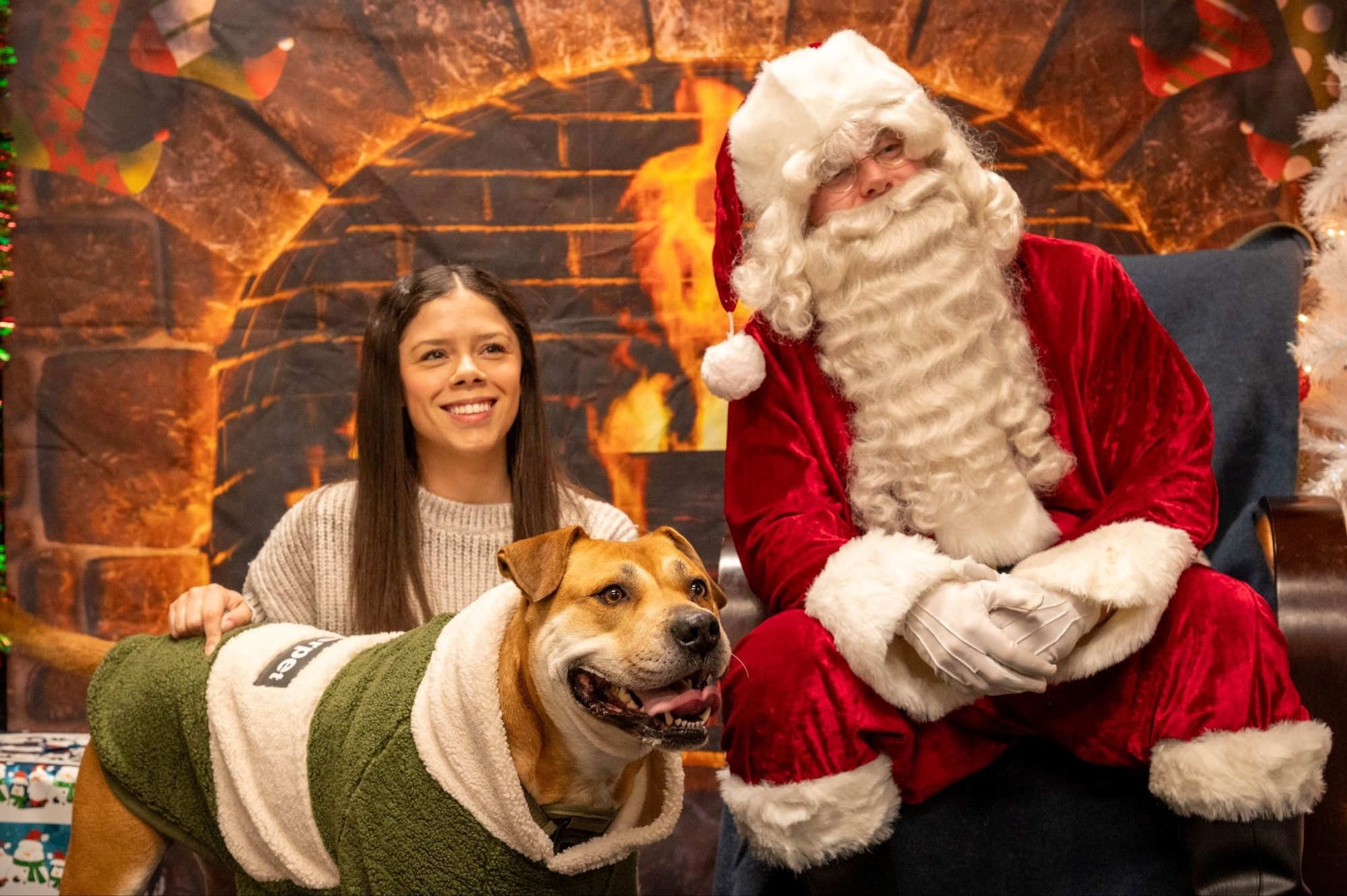 A volunteer dressed Santa Claus poses for a photo with an attendee and her pet during the 2025 Santa Paws event at Misawa Air Base, Japan, Dec. 6, 2025. The event brought Team Misawa’s families and their furry companions together for a cheerful holiday moment, lifting morale and reinforcing the community connection that fuels the 35th Fighter Wing’s unified strength. (U.S. Air Force photo by Airman 1st Class Jessel Fabara)