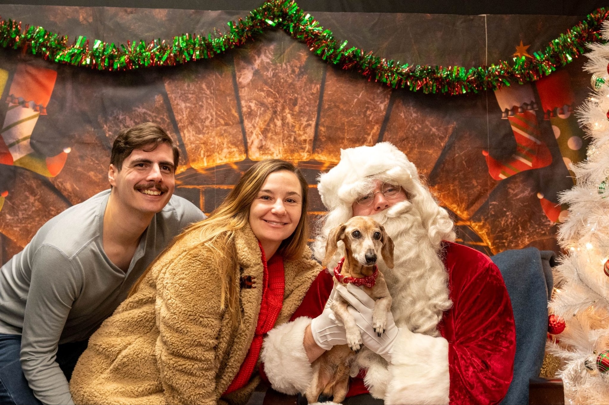 Volunteers and their pet pose for a photo with Santa Claus during the 2025 Santa Paws event at Misawa Air Base, Japan, Dec. 6, 2025. The event offered the Misawa community a playful holiday experience with their furry family members, reinforcing the sense of connection that supports the 35th Fighter Wing’s unified mission. (U.S. Air Force photo by Airman 1st Class Jessel Fabara)