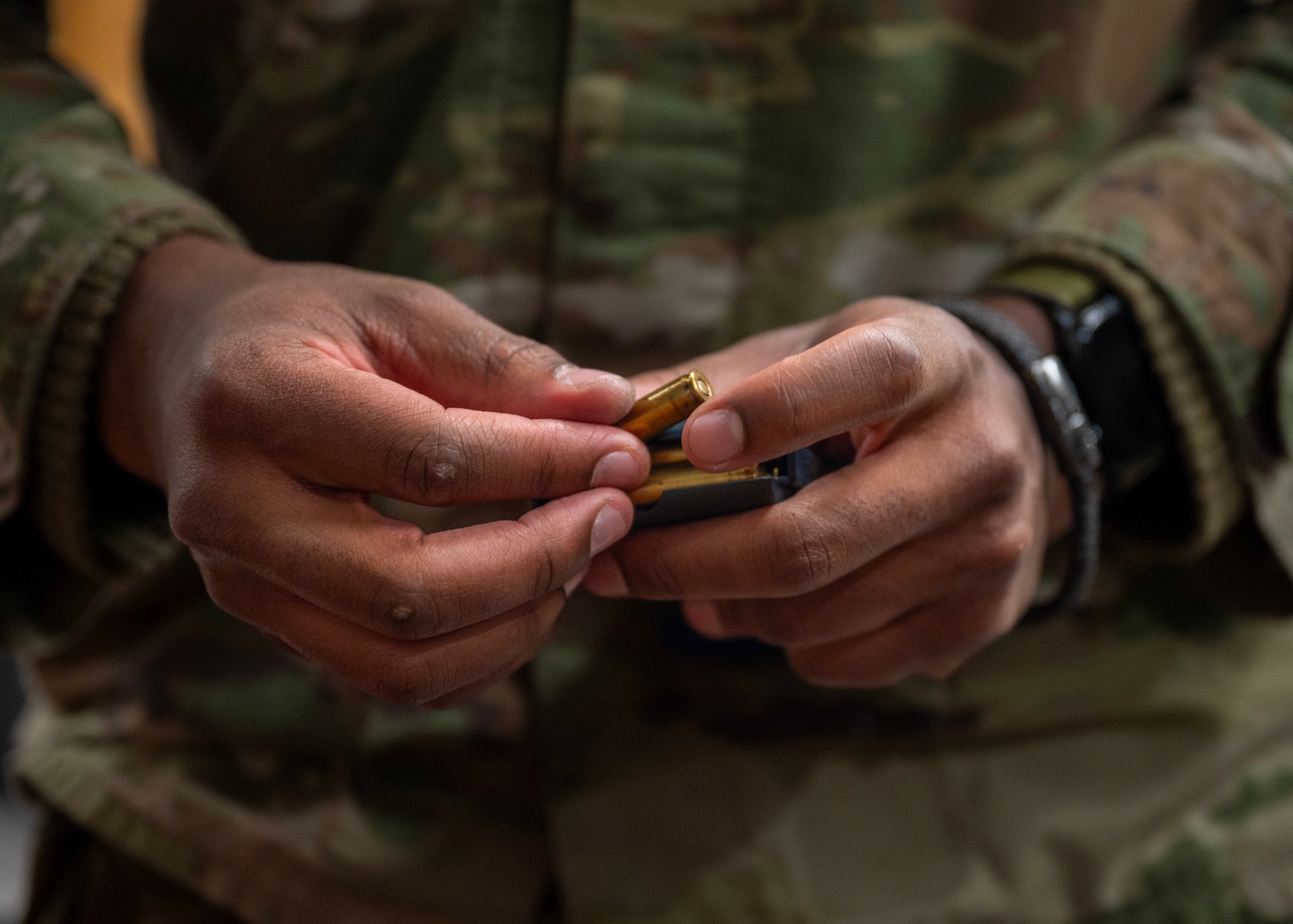 Blank rounds are loaded for asset defense training during MUSTANG RODEO 26-1 at Osan Air Base, Republic of Korea, Dec. 9, 2025. MUSTANG RODEO provides regular opportunities for Airmen to rehearse targeted skill sets and bridge the gap between large-scale events. This ensures that critical tasks are performed with speed and precision, even when operating under limited time or simulated operational stress. (U.S. Air Force photo by Staff Sgt. Sarah Williams)