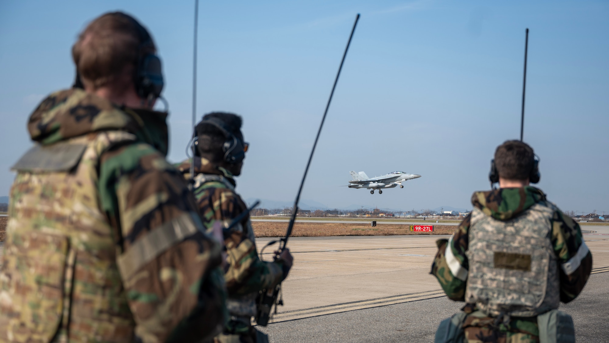 Members of the 51st Operations Support Squadron air traffic control direct a take off during MUSTANG RODEO 26-1 at Osan Air Base, Republic of Korea, Dec. 10, 2025. MUSTANG RODEO is a week of focused unit training where squadrons plan and execute part task events to practice the skills Osan Airmen need during contingency operations. (U.S. Air Force photo by Staff Sgt. Sarah Williams)