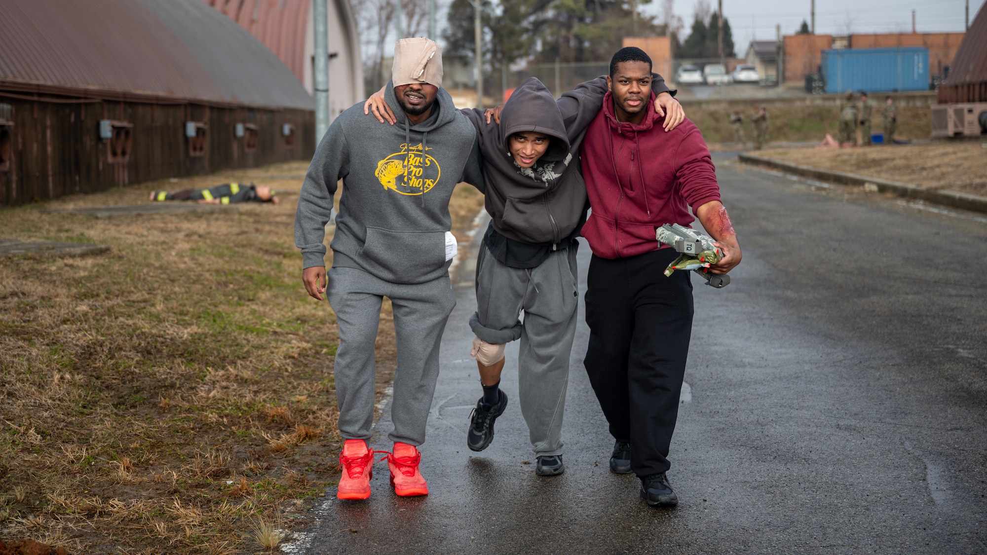 Participants of a Tactical Combat Casualty Care exercise work together to move towards aid during MUSTANG RODEO 26-1 at Osan Air Base, Republic of Korea, Dec. 10, 2025. Airmen from multiple career fields played vital roles in ensuring mission success throughout MUSTANG RODEO 26-1 through their adaptability, teamwork and attention to detail reflecting the wing’s ability to operate in dynamic, high-pressure environments. (U.S. Air Force photo by Staff Sgt. Sarah Williams)