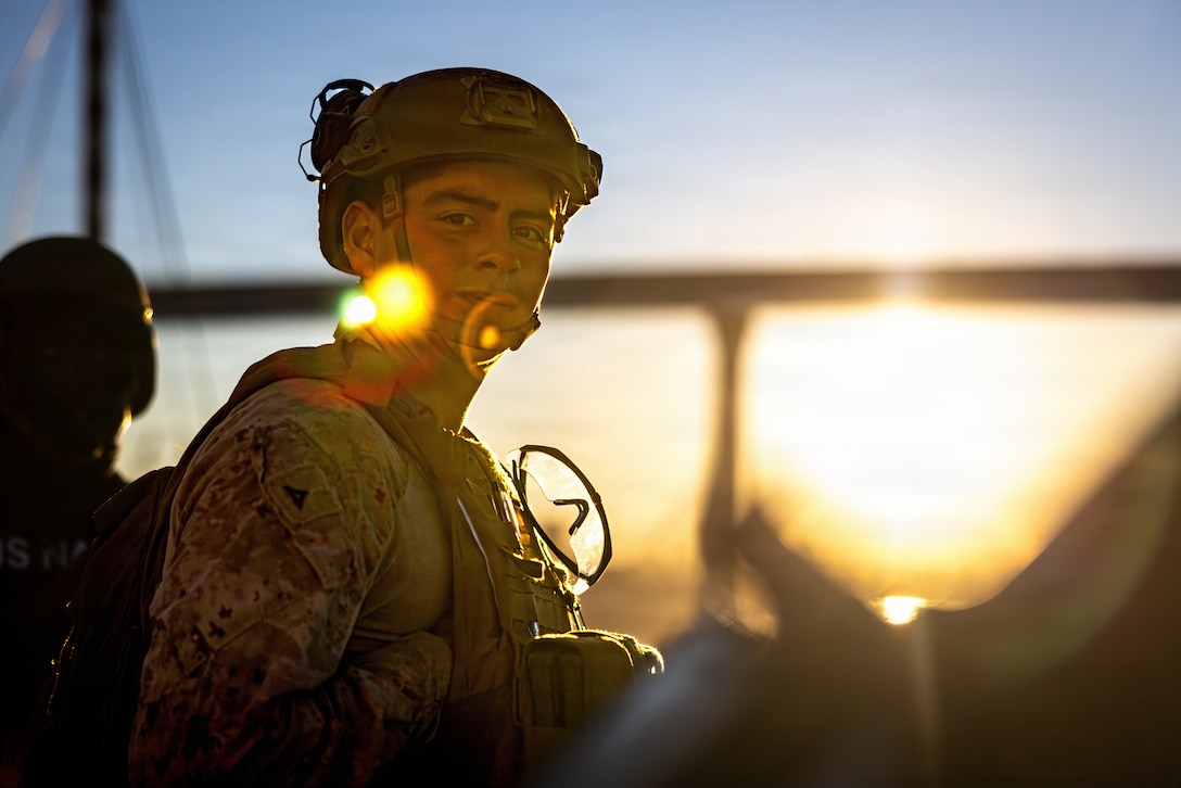 A U.S. Marine with Kilo Company, Battalion Landing Team 3/5, 11th Marine Expeditionary Unit, conducts a defense of the amphibious task force drill while pulling into port aboard Whidbey Island-class dock landing ship USS Comstock (LSD 45) in San Diego, California, Dec. 10, 2025. The 11th MEU is currently underway aboard the Boxer Amphibious Ready Group in the U.S. 3rd Fleet area of operations conducting integrated training that enhances lethality and warfighting readiness. (U.S. Marine Corps photo by Sgt. Trent A. Henry)