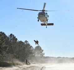 Naval Air Station (NAS) Patuxent River Search and Rescue (SAR) aircrew hoists a simulated patient in a rescue litter into an MH-60S Seahawk helicopter. This training tests the crew’s ability to safely extract a patient and prepare them for transport to a higher echelon of care, a critical skill for newly qualified L00A corpsmen like Hospital Corpsman 3rd Class Arsides Garay.