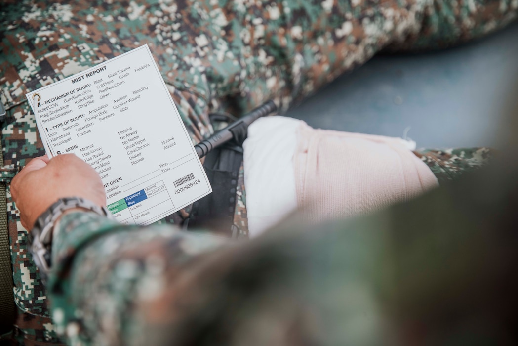 A Philippine Marine assigned to 3rd Marine Brigade prepares to fill out a mechanism, injuries, symptoms and treatment report during a tactical combat casualty care subject matter expert exchange with U.S. Marines assigned to Marine Rotational Force-Southeast Asia, I Marine Expeditionary Force, and Philippine Coast Guardsmen as part of exercise Marine Air Support Activity 2025 at Marine Base Camp Rodolfo, Palawan, Philippines, Oct. 13, 2025. TCCC is a training program for non-medical personnel to have knowledge and skills to render life-saving medical aid in the absence of medical personnel in combat scenarios.  MASA 25 is an annual joint Philippine and U.S. military exercise focused on mutual defense, strengthening relationships, and rehearsing emerging aviation concepts. (U.S. Marine Corps photo by Sgt. Luis Agostini)