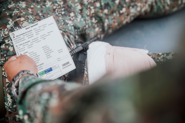 A Philippine Marine assigned to 3rd Marine Brigade prepares to fill out a mechanism, injuries, symptoms and treatment report during a tactical combat casualty care subject matter expert exchange with U.S. Marines assigned to Marine Rotational Force-Southeast Asia, I Marine Expeditionary Force, and Philippine Coast Guardsmen as part of exercise Marine Air Support Activity 2025 at Marine Base Camp Rodolfo, Palawan, Philippines, Oct. 13, 2025. TCCC is a training program for non-medical personnel to have knowledge and skills to render life-saving medical aid in the absence of medical personnel in combat scenarios.  MASA 25 is an annual joint Philippine and U.S. military exercise focused on mutual defense, strengthening relationships, and rehearsing emerging aviation concepts. (U.S. Marine Corps photo by Sgt. Luis Agostini)